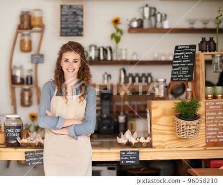 Can I help you. Portrait of an attractive young barista starting at a cafe counter. 96058210