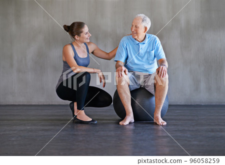Helping my patients recover is my only priority. Shot of a a physical therapist working with a senior man. 96058259