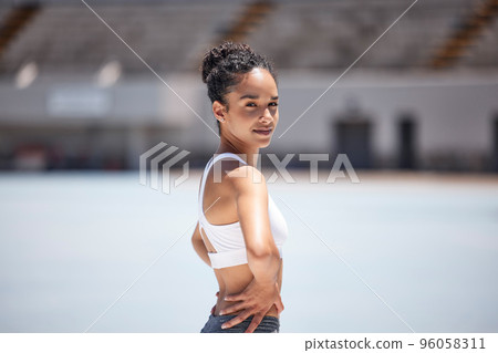 Woman portrait, athlete and fitness in an outdoor stadium happy about exercise, training and run. Black woman sports runner with a smile with happiness of health workout and sport goals outdoor Woman portrait, athlete and fitness in an outdoor stadium happy about exercise, training and run. Black woman sports runner with a smile with happiness of health workout and sport goals outdoor 96058311