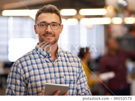Smart technology makes everything easier. Cropped portrait of a mature businessman standing with a digital tablet in the office. Smart technology makes everything easier. Cropped portrait of a mature businessman standing with a digital tablet in the office. 96058579