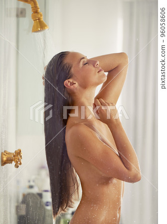 A refreshing morning shower. Cropped shot of a woman showering. 96058606