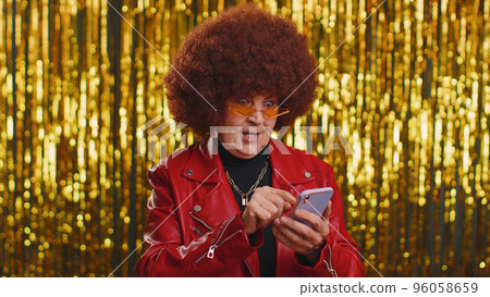 Happy excited woman use mobile phone say wow yes found out great big win news doing winner gesture Happy excited woman use mobile phone say wow yes found out great big win news doing winner gesture 96058659