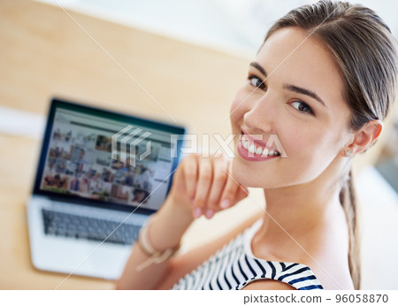 Design is in my blood. Portrait of a young office worker sitting at her workstation in an office. Design is in my blood. Portrait of a young office worker sitting at her workstation in an office. 96058870