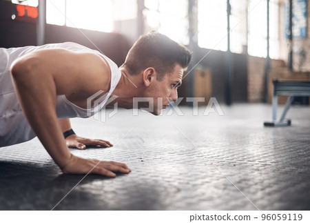 You were built to be the best. Shot of a young man doing pushups in a gym. 96059119
