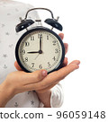 Woman hands holding black alarm clock 96059148