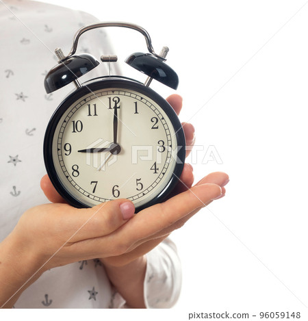 Woman hands holding black alarm clock Woman hands holding black alarm clock 96059148