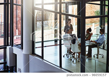 Business discussions in progress. Shot of a group of businesspeople having a meeting in a boardroom. Business discussions in progress. Shot of a group of businesspeople having a meeting in a boardroom. 96059157