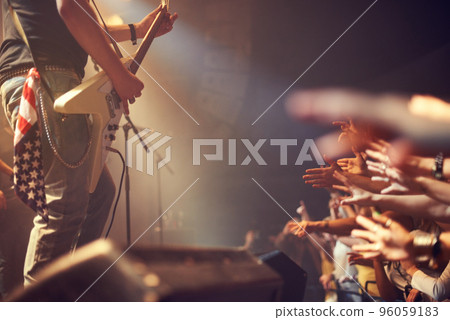 I love rock and roll. A talented guitarist rocking out on stage. 96059183