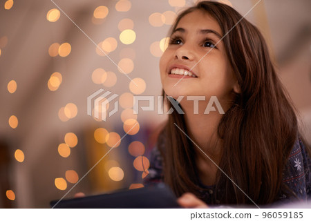You learn something new every day. Shot of a cute little girl using a digital tablet. 96059185