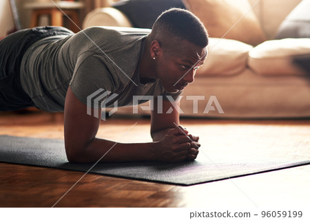 Make time for the things that benefit you. Shot of a young man practising yoga at home during the day. Make time for the things that benefit you. Shot of a young man practising yoga at home during the day. 96059199