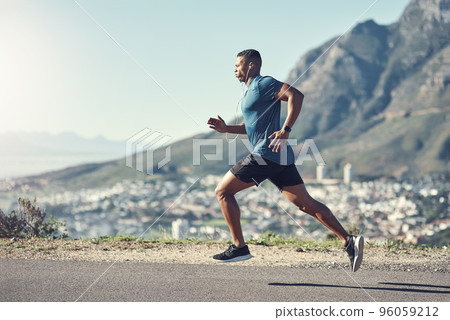 Running is one of the best ways to stay fit. Shot of a young handsome man running outdoors. 96059212