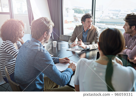 The ideas are flowing.... Shot of a group of coworkers having a brainstorming session in an office boardroom. The ideas are flowing.... Shot of a group of coworkers having a brainstorming session in an office boardroom. 96059331