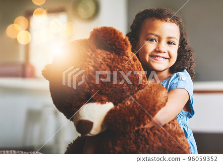 I dont go anywhere without him. Portrait of a little girl holding her teddy bear at home. I dont go anywhere without him. Portrait of a little girl holding her teddy bear at home. 96059352