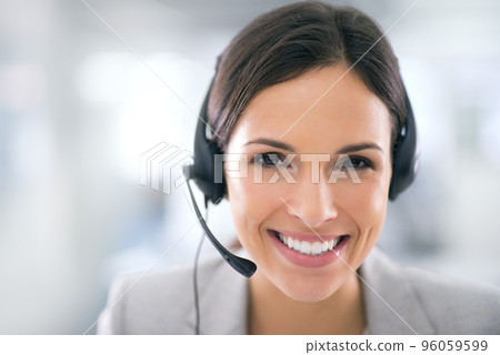 She goes the extra mile for her clients. Shot of an attractive customer support agent. She goes the extra mile for her clients. Shot of an attractive customer support agent. 96059599