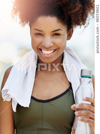 Staying hydrated is essential for your health. Cropped shot of a young woman enjoying a bottle of water while out for a run. Staying hydrated is essential for your health. Cropped shot of a young woman enjoying a bottle of water while out for a run. 96059601