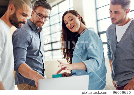 Making tomorrows success today. Shot of a group of coworkers having a meeting in an open plan office. 96059630