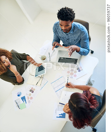 Nothing says success like strategy. Shot of a group of colleagues having a meeting in a modern office. 96059737