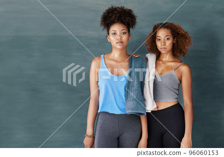 Were focused on fitness. Studio portrait of two young women after yoga class against a grey background. 96060153