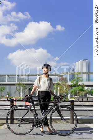 Road bike and business woman side view full body 96060227