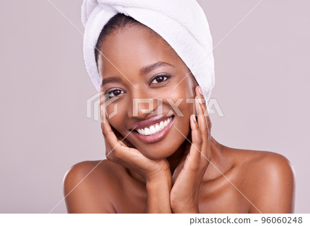 To be beautiful is to be yourself. An isolated studio portrait of a beautiful young woman wearing a towel on her head. To be beautiful is to be yourself. An isolated studio portrait of a beautiful young woman wearing a towel on her head. 96060248