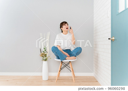 Japanese woman spraying her throat Japanese woman spraying her throat 96060298