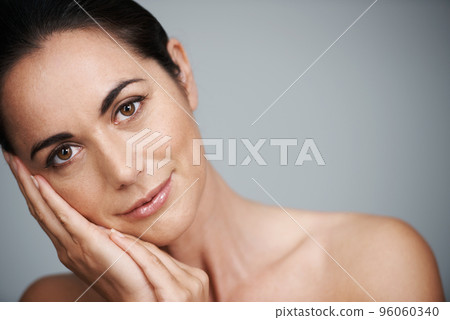 Beauty with no best-before date. Cropped studio shot of a beautiful mid adult woman touching her face. 96060340