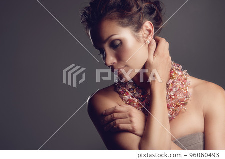 Dressed to impress. A mature woman wearing a stunning necklace. 96060493