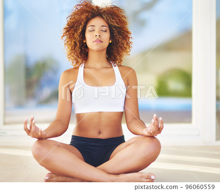Learn to embrace your flaws. Shot of a young woman practising her yoga routine. 96060559