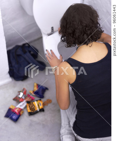 Say no to sugar. A young woman holding baked goods with her mouth covered. Say no to sugar. A young woman holding baked goods with her mouth covered. 96061443
