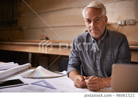 Turning his vision into reality. An architect drawing up plans. 96061521