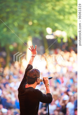 Enjoying the music festival. Cropped shot of a large crowd at a music concert. 96061819