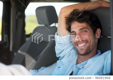 Theres no where else Id rather be. A young man enjoying his vacation road trip with a smile. Theres no where else Id rather be. A young man enjoying his vacation road trip with a smile. 96061908