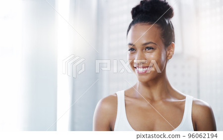 Beauty personified. Shot of an attractive young woman admiring her face in the bathroom at home. Beauty personified. Shot of an attractive young woman admiring her face in the bathroom at home. 96062194