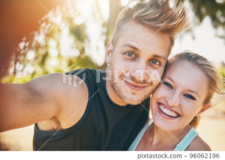 I smile more since I met you. Shot of a young couple smiling outdoors. I smile more since I met you. Shot of a young couple smiling outdoors. 96062196