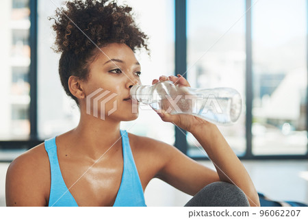 Taking some liquids on board. Cropped shot of a young woman drinking some water after yoga class. 96062207