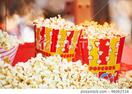 The perfect movie snack. Cropped view of freshly popped corn in packages. 96062516