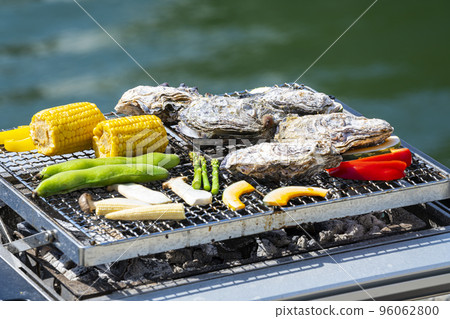 Roast oysters on a seaside barbecue 96062800