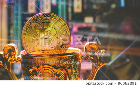 Cryptocurrency concept , Golden bitcoin on winners cup background mainboard , The future of money. Computational equipment. 96062891