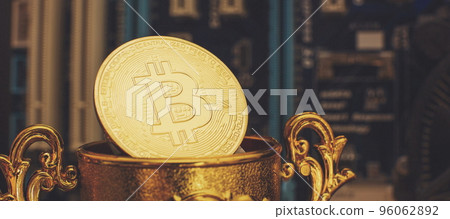 Cryptocurrency concept , Golden bitcoin on winners cup background mainboard , The future of money. Computational equipment. Cryptocurrency concept , Golden bitcoin on winners cup background mainboard , The future of money. Computational equipment. 96062892