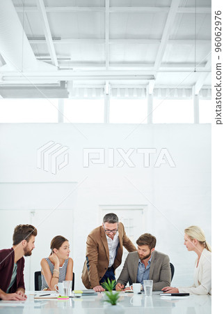 Brainstorming for future success. A group of coworkers standing around a table. 96062976