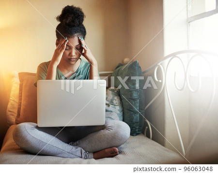 Studying is too much. Full length shot of a young female student studying at home. Studying is too much. Full length shot of a young female student studying at home. 96063048