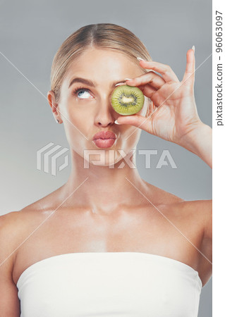 Thinking, beauty and woman with kiwi face for organic skincare, health and cosmetic product. Thoughtful skin model girl for fruit cosmetic treatment marketing with gray gradient background. Thinking, beauty and woman with kiwi face for organic skincare, health and cosmetic product. Thoughtful skin model girl for fruit cosmetic treatment marketing with gray gradient background. 96063097