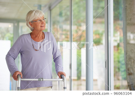 Every reason to be positive. Shot of a senior woman using an orthopedic walker indoors. Every reason to be positive. Shot of a senior woman using an orthopedic walker indoors. 96063104