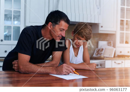 Getting children involved in household chores has benefits for everyone. Cropped shot of a father going over a list of chores with his son at home. 96063177