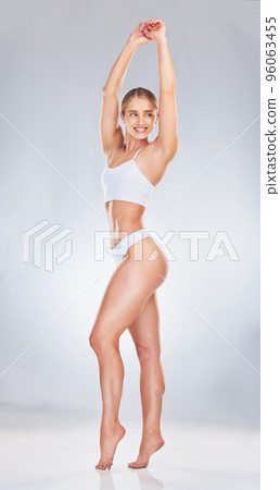 Body, underwear and beauty with a model woman in studio on a gray background to promote natural wellness. Fitness, exercise and health with an attractive young female inside to promote a healthy diet 96063455