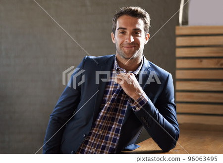 Can I buy you a drink. Portrait of a handsome young man standing happily next to a bar counter. Can I buy you a drink. Portrait of a handsome young man standing happily next to a bar counter. 96063495