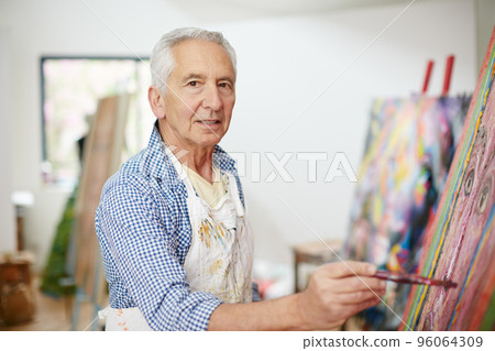 Life isnt about finding yourself, its about creating yourself. Shot of a senior man working on a painting at home. 96064309