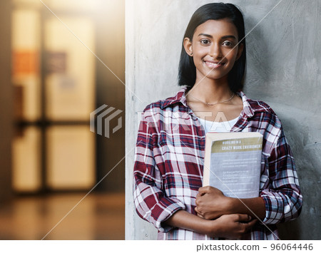 Im looking forward to my first class. Cropped portrait of an attractive young female student standing outside on campus. 96064446