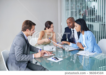 The business strategists. Shot of a group of businesspeople going over documents during a meeting. The business strategists. Shot of a group of businesspeople going over documents during a meeting. 96064584