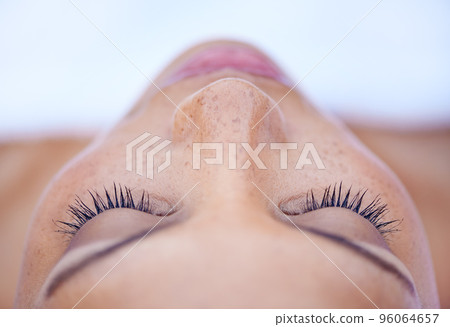 Shes in a deeply relaxed state of mind. Cropped shot of an attractive young woman lying on her back. Shes in a deeply relaxed state of mind. Cropped shot of an attractive young woman lying on her back. 96064657